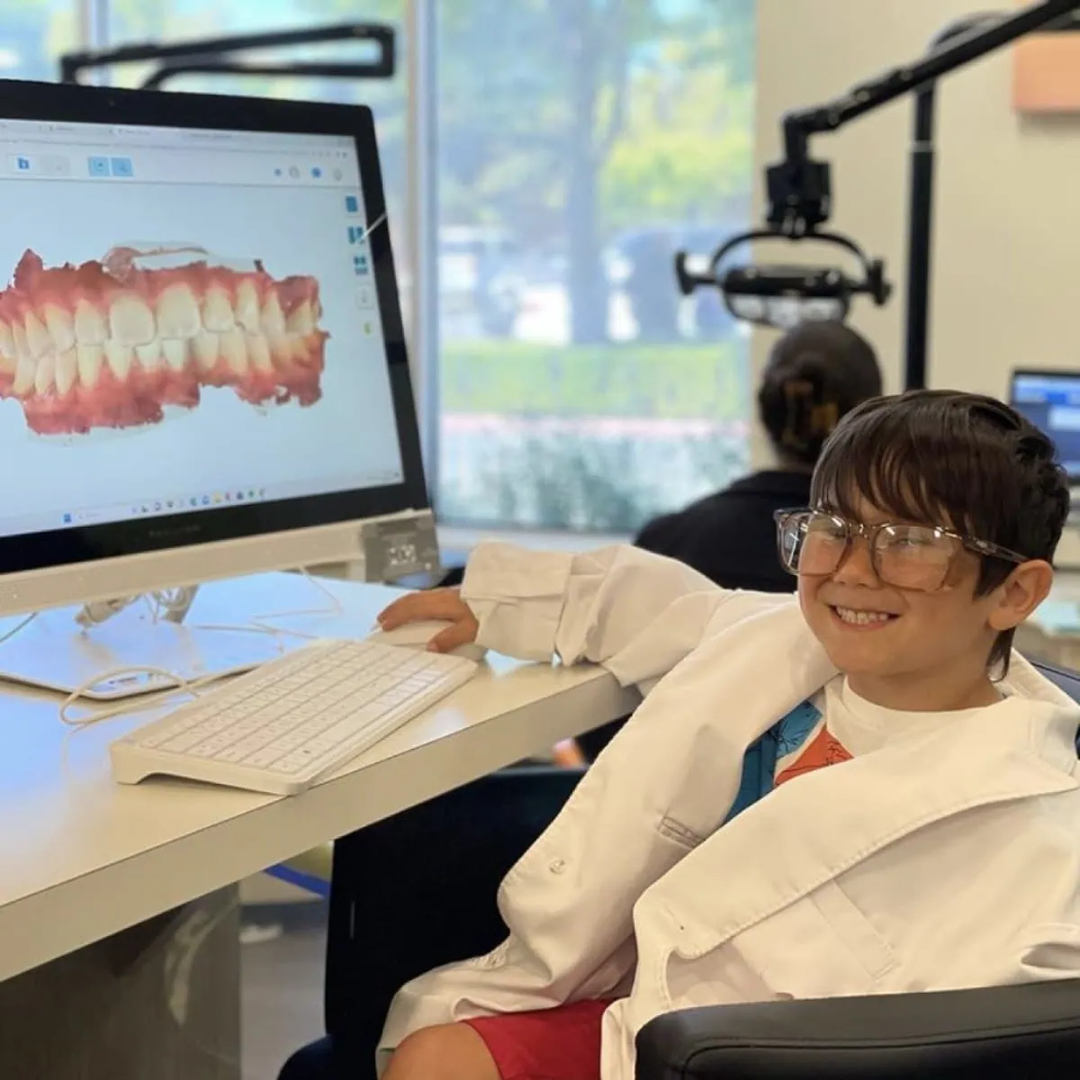 Orthodontist examining 3D model of braces and teeth, modern braces solutions in Salinas, CA.